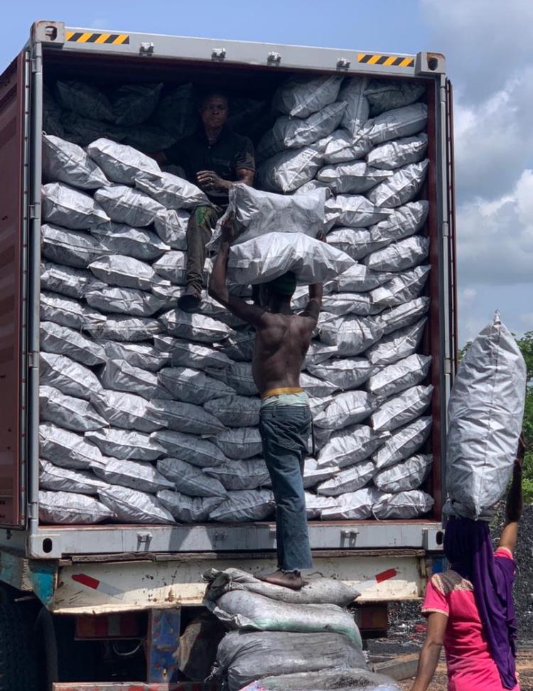 loading charcoal into a container for export